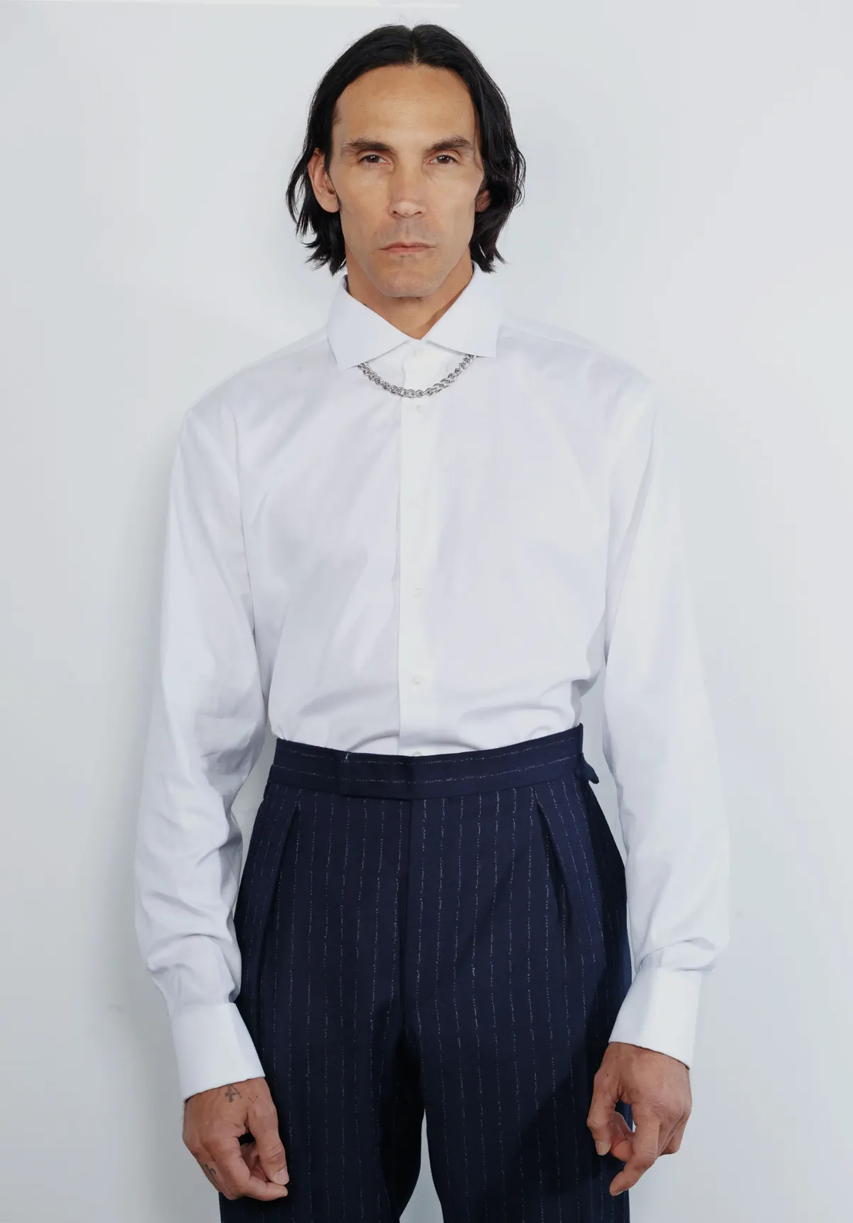 <p style="text-align:right;">GIEVES &amp; HAWKES shirt and trousers, TOM WOOD chain necklace.</p>