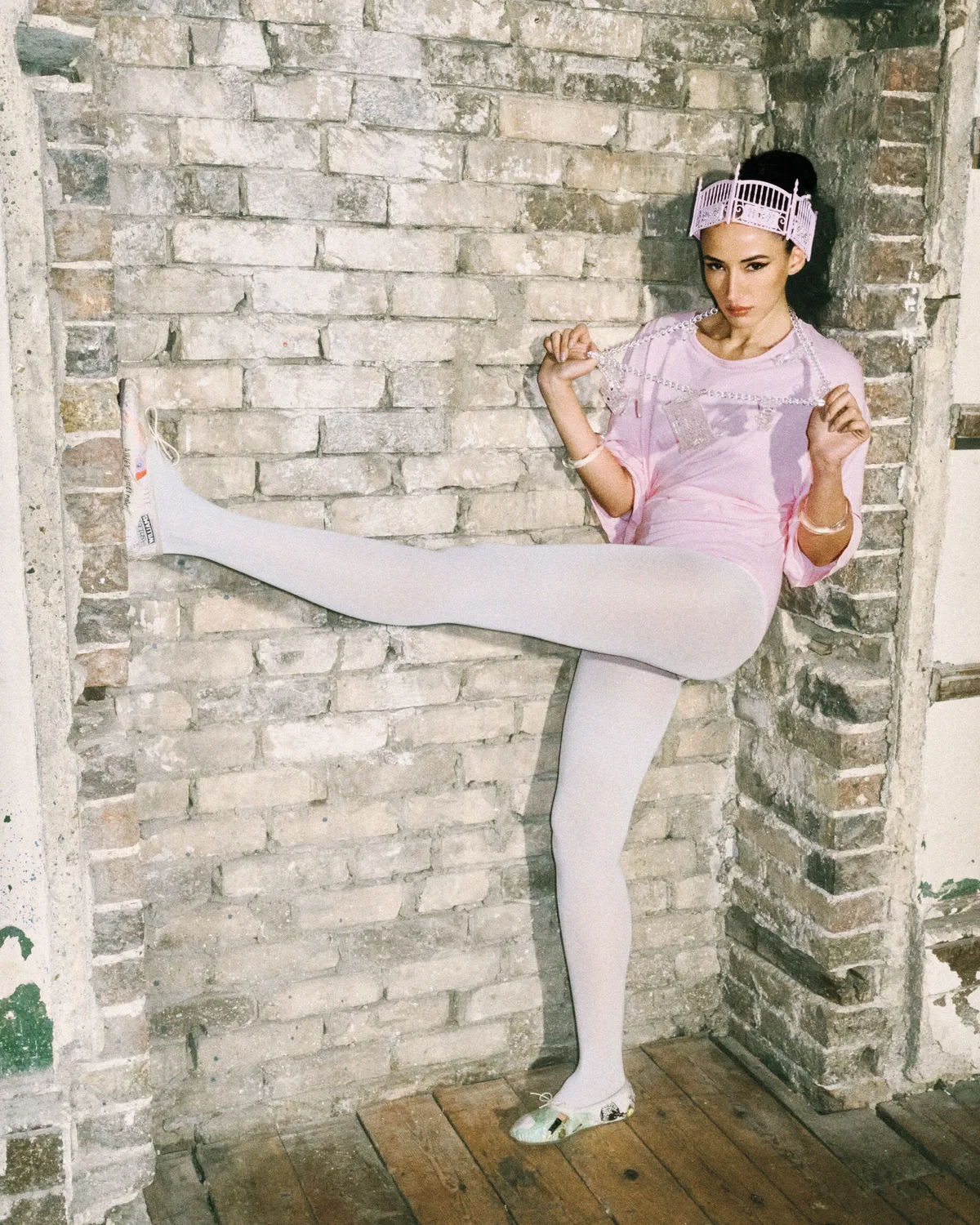 <p>ASHLEY WILLIAMS bodysuit, necklace, crown, shoes, ALEXIS BITTAR bracelets and CALZEDONIA tights.</p>